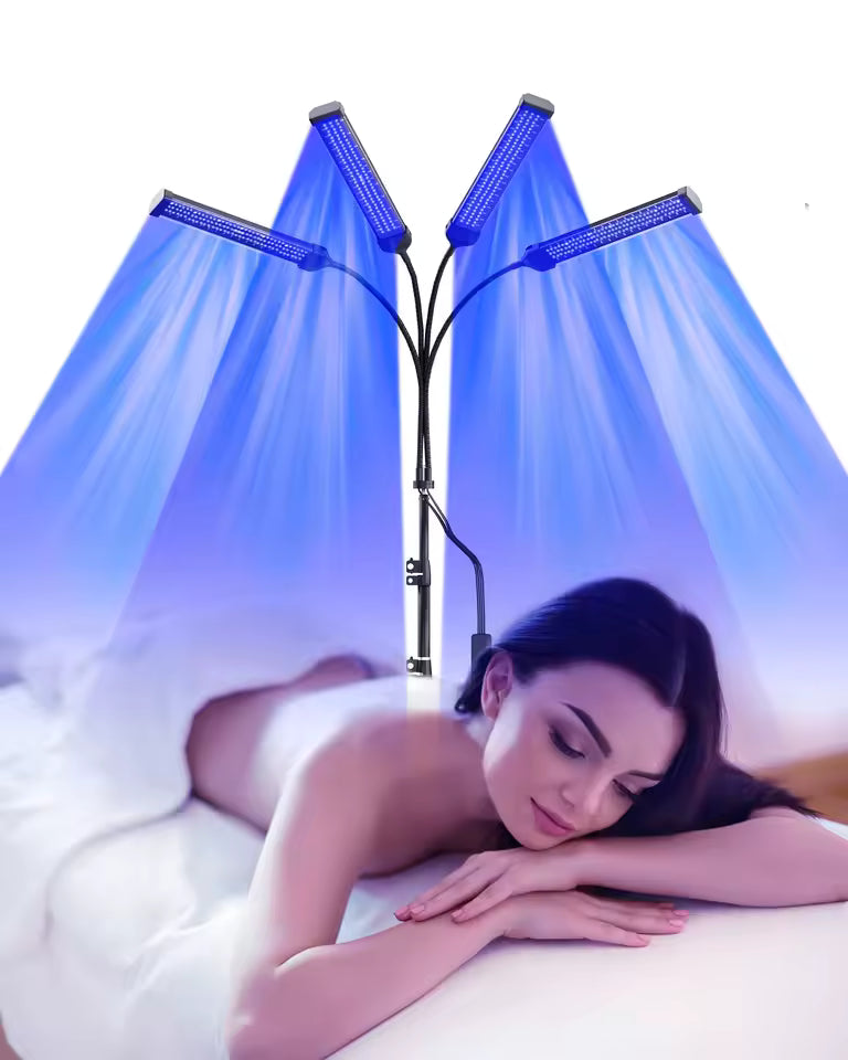 Woman lying on a bed with a LED light therapy lamp above her