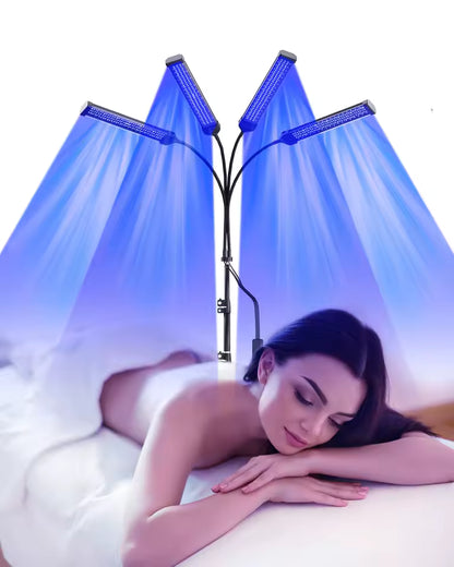 Woman lying on a bed with a LED light therapy lamp above her