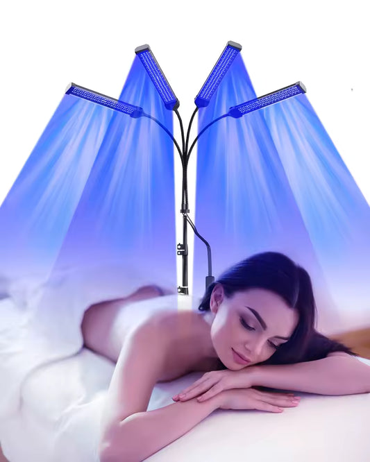 Woman lying on a bed with a LED light therapy lamp above her